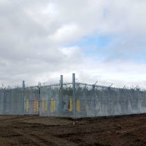 Industrial, security fence around natural gas pipeline